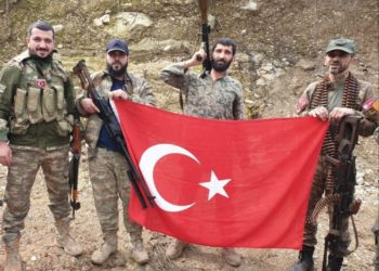 Former official of Turkey’s ruling party pictured brandishing severed head in Syria