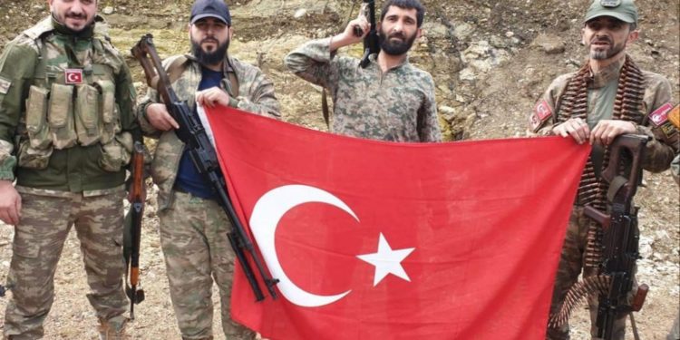 Former official of Turkey’s ruling party pictured brandishing severed head in Syria